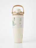 Owala FreeSip Tumbler with travel-grip handle in Cream, hero shot